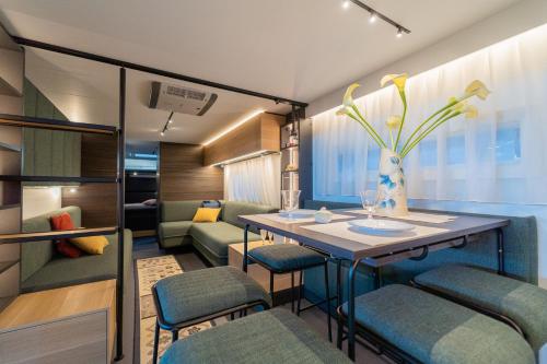 a dining room with a table and chairs at Club del Sole Adriano Family Collection in Punta Marina
