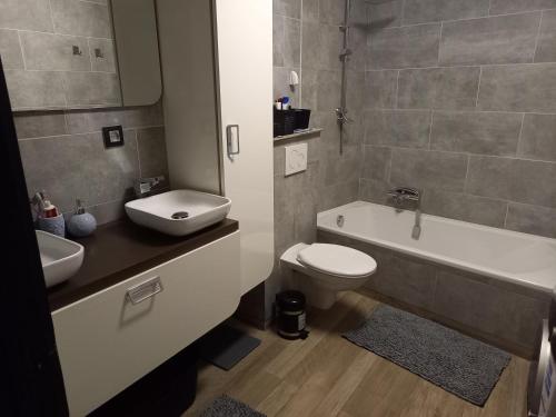a bathroom with a sink and a toilet and a bath tub at @Zakibelle in Bredene