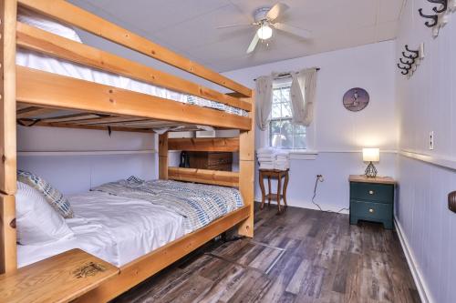 a bedroom with two bunk beds and a ceiling fan at West Bay Pines in Saint Germain