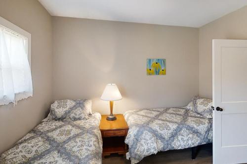 a bedroom with two beds and a lamp on a table at The Bird House on Turtle Bay in Nashville