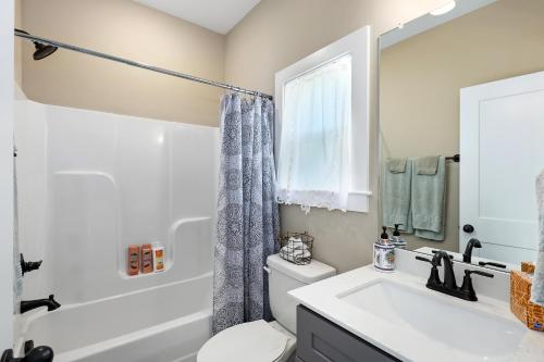 a bathroom with a sink and a toilet and a tub at The Bird House on Turtle Bay in Nashville