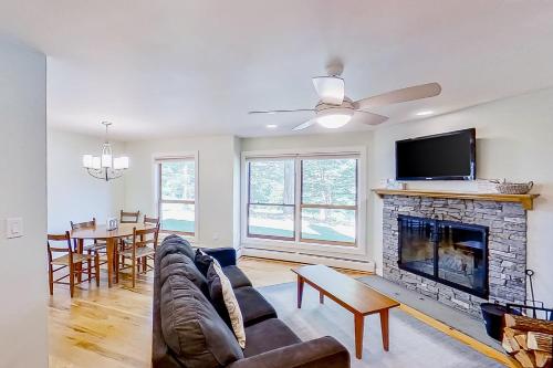 a living room with a couch and a fireplace at Outer Limits in Killington