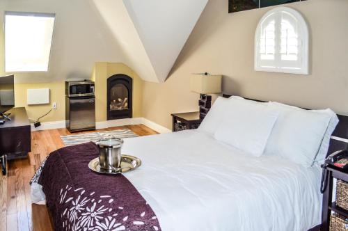 a bedroom with a bed with a tray on top of it at Rio Vista Inn & Suites Santa Cruz in Santa Cruz