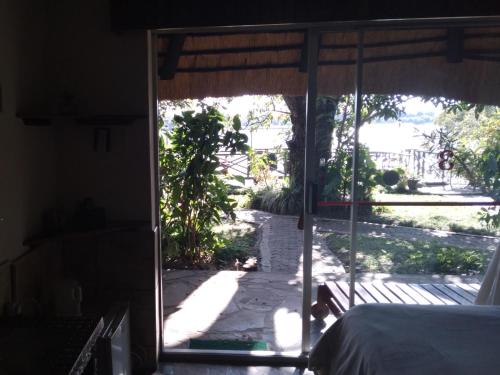 an open door to a patio with a bed at Caprivi River Lodge in Katima Mulilo
