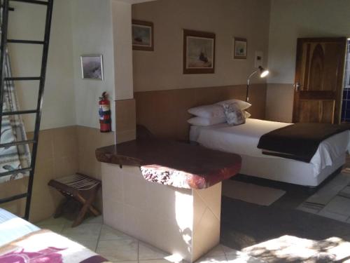 a hotel room with two beds and a bench at Caprivi River Lodge in Katima Mulilo