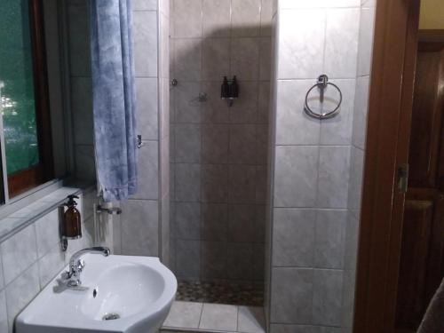 a bathroom with a shower and a sink at Caprivi River Lodge in Katima Mulilo