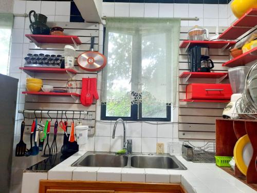 a kitchen with a sink and a window at La Terraza del Pochote in Oaxaca City