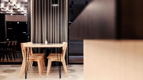 a table and chairs in a room with a table at Penzion Blanko in Nová Bystřice