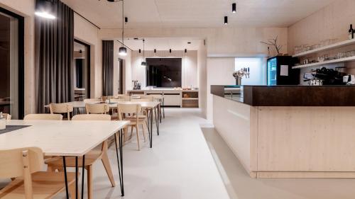 a kitchen and dining room with tables and chairs at Penzion Blanko in Nová Bystřice