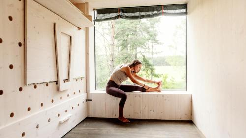 a woman sitting on a window sill in a room at Penzion Blanko in Nová Bystřice