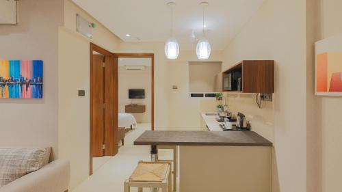a small apartment with a kitchen and a living room at AR Suites Jewels Royale - Koregaon Park NX in Pune