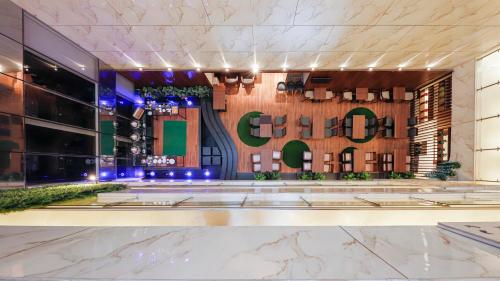 a lobby of a hotel with a sign that reads gucci at AR Suites Jewels Royale - Koregaon Park NX in Pune