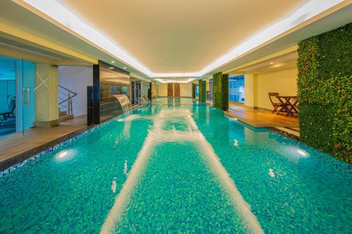 a large swimming pool in a hotel room at AR Suites Jewels Royale - Koregaon Park NX in Pune