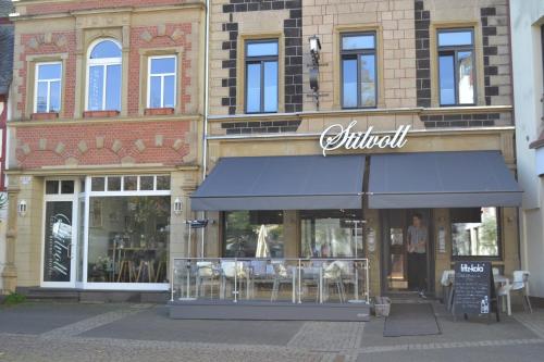 a store with a blue awning in front of a building at Boutique-Hotel "Stilvoll" in Andernach