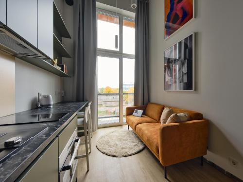 a living room with a couch in a kitchen at Campus House by Larsen in Tallinn