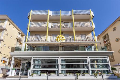 a large building with a balcony on top of it at Hotel Brotas in Rimini