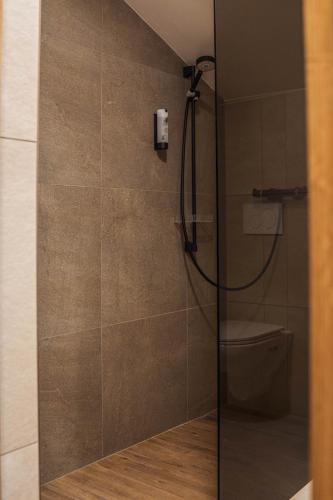 a shower with a glass door in a bathroom at Bergrose Hideaway in Strobl