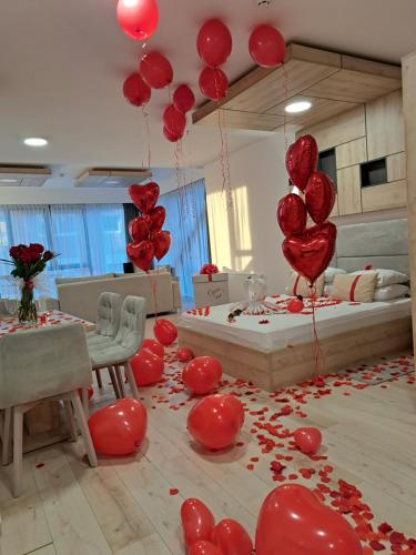 a room with red balloons and red hearts on the floor at Aparthotel Centar Sarajevo in Sarajevo