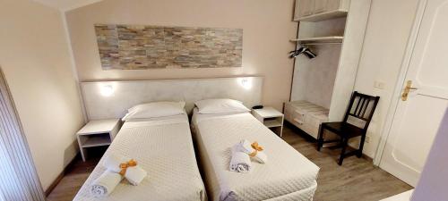 a small room with two beds in a room at HOTEL ALBA in Montecatini Terme