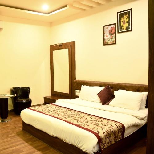 a bedroom with a large bed with a mirror at Hotel Saroj Sagar in Sāgar