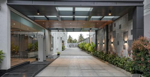 an empty hallway of a building with plants at The Sulit Whitefield in Bengaluru