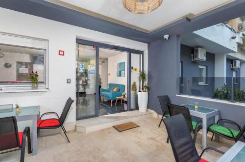 a restaurant with tables and chairs in a room at Marine Lux apartments in Pula