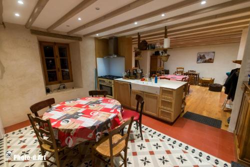 a kitchen with a table with a tablecloth on it at Maison écologique pleine montagne (eco-gite gavarnie) in Gèdre