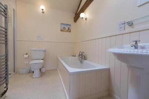 a bathroom with a toilet and a sink at Hulmes Vale House - Sleeps 14 - Peak district in Buxton