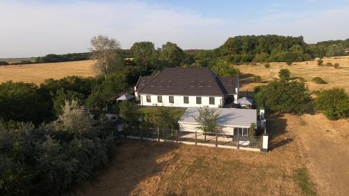 an aerial view of a house in a field at Földi Paradicsom Vendégház in Hajdúszoboszló