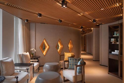 a waiting room with chairs and mirrors on the wall at Hyatt Regency Phnom Penh in Phnom Penh