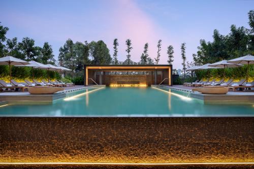 a rendering of a swimming pool with chairs and umbrellas at Hyatt Regency Phnom Penh in Phnom Penh
