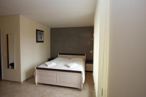 a bedroom with a bed with two towels on it at Hotel Da Gianni GmbH in Oranienburg