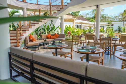 a patio at the resort with tables and chairs at Kalia Bingin - Adult only in Uluwatu