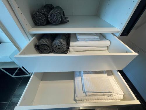 an open refrigerator with towels and other items at Bardolino Luxury in Bardolino