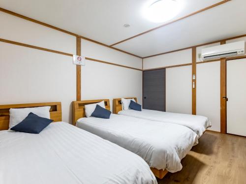 Postel nebo postele na pokoji v ubytování Tabist Hotel Aihama Beppu