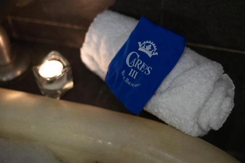a roll of toilet paper with a blue tag on it at Hotel Real Balneario Carlos III in Trillo