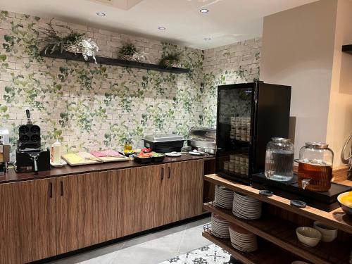 a restaurant kitchen with a counter with food at Hotel Floris Arlequin Grand-Place in Brussels