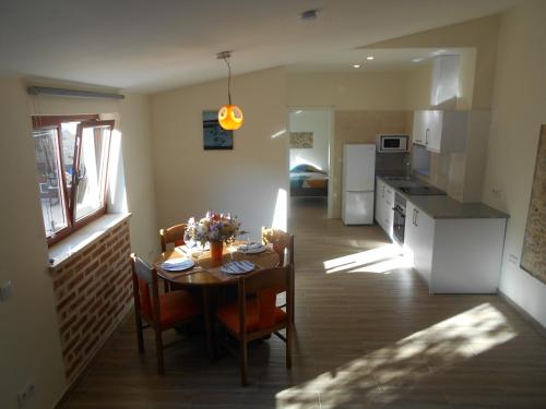 a kitchen and dining room with a table and chairs at Casa do forno in Salir de Porto