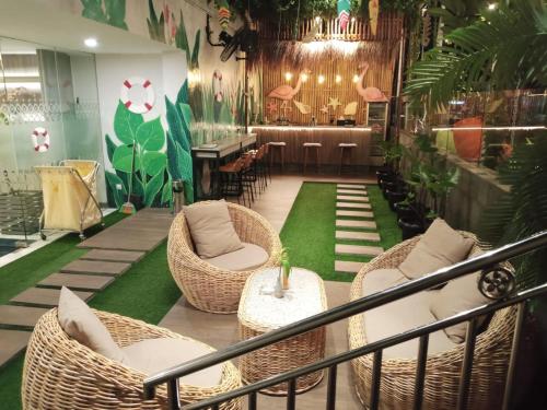 a restaurant with wicker chairs and a bar at Zigna Kampung Batik in Solo