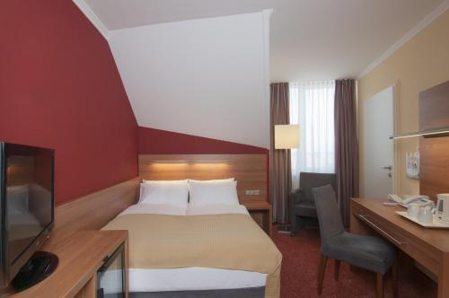 Postel nebo postele na pokoji v ubytování Holiday Inn Munich Unterhaching by IHG
