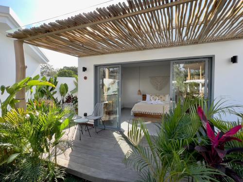 a master bedroom with a bed and a deck with plants at Kalia Bingin - Adult only in Uluwatu