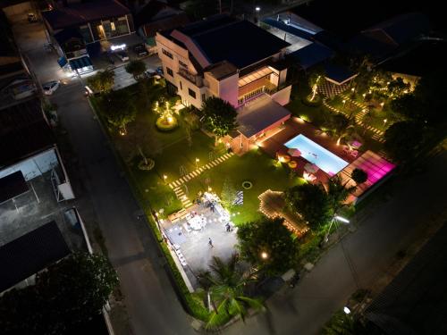 an overhead view of a courtyard at night with lights at The Modeva Hotel in Kanchanaburi