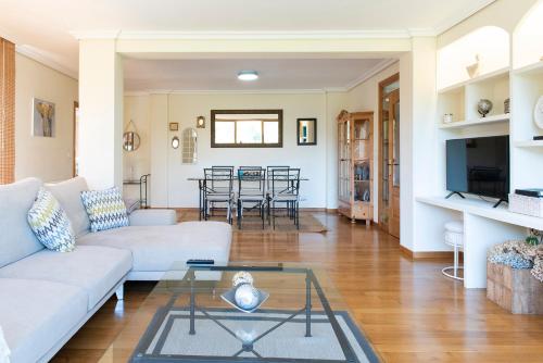 a living room with a couch and a table at Villa El Castañal con Piscina Privada in Vigo