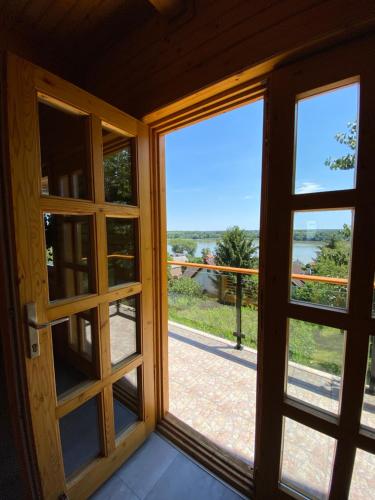 an open door with a view of a porch at Panoráma Faház Mohács in Mohács