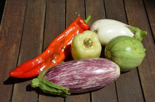 a group of vegetables sitting on a wooden table at Chambres d'Hôtes Domaine du Hameau Baylesse in Saint-Jean-dʼAigues-Vives