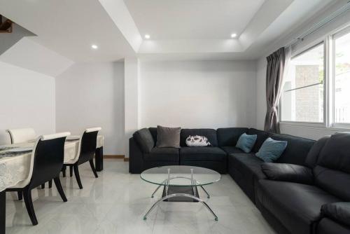 a living room with a couch and a table at Basic Line Villa เบสิค ไลน์ วิลล่า in Chiang Mai