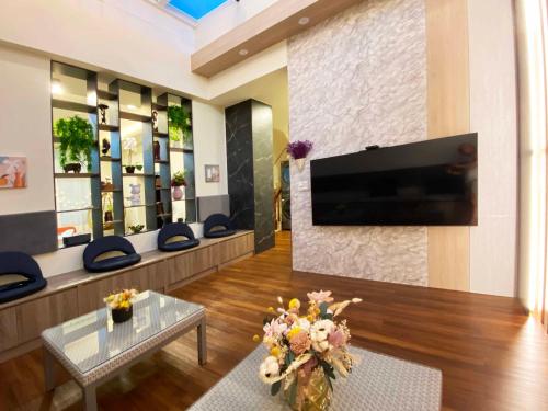 a living room with a flat screen tv on a wall at 1881 Ya ka Hostel in Tainan