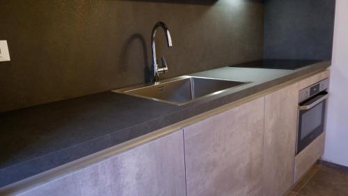 a kitchen with a sink and a counter at Pianomare Riviera Apartments and Rooms in Imperia