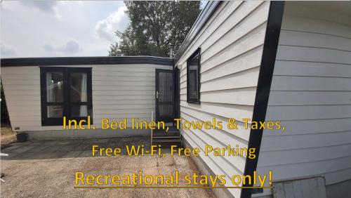 a house with the words inert bed linen towels and taxes free wifi fire at Gezellig familie chalet tot 6 personen op de Veluwe Bungalowpark De Kern in Putten