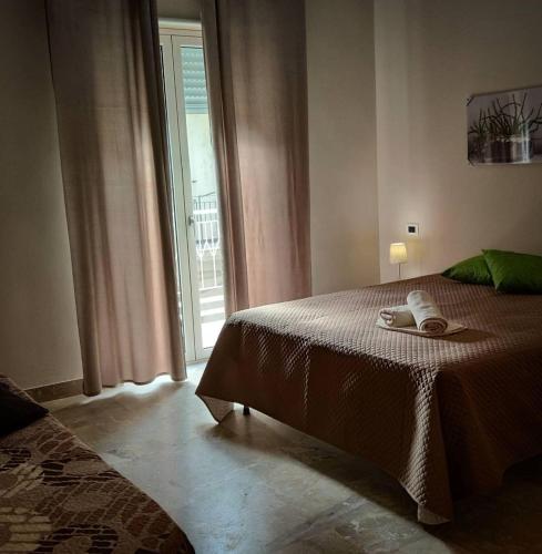 a bedroom with a bed and a large window at La Margherita - Casa vacanze in Montallegro